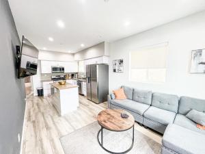 a living room with a couch and a table at Spacious 4BR Townhouse in Mid City - WH-C2 in Los Angeles