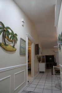 a hallway with a plant and a banana on the wall at 3-bedroom home between the beach & theme parks in Deltona
