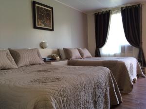Ліжко або ліжка в номері Motel de la Pente Douce
