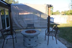 two chairs and a fire pit on a patio at 3-bedroom home between the beach & theme parks in Deltona