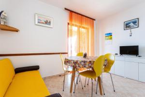 ein Esszimmer mit einem Tisch und gelben Stühlen in der Unterkunft Secluded fisherman's cottage Cove Virak, Hvar - 17875 in Gdinj