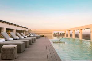 a hotel pool with lounge chairs and a swimming pool at Four Points by Sheraton Nairobi Airport in Nairobi