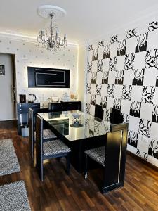 a dining room with a black and white patterned wall at The Arabella House - New Cairo in Cairo