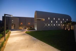 a modern house with a long driveway at Domes Noruz Chania, Autograph Collection- Adults Only in Kato Daratso