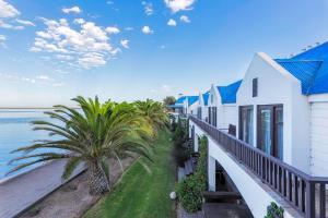 a view of the ocean from the balcony of a house at Protea Hotel by Marriott Walvis Bay Pelican Bay in Walvis Bay