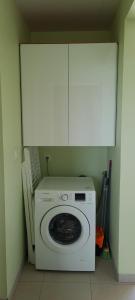 a white washing machine in a room with cabinets at VILLA LINEDDY/ZINNIA in Quartier la Fleury Guiné