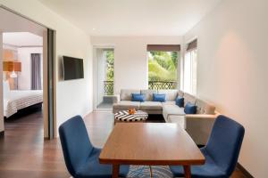 a living room with a couch and a table at Le Meridien Goa, Calangute in Calangute