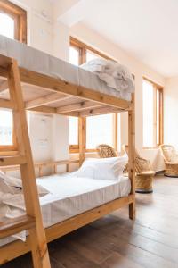 a bedroom with two bunk beds in a room at The Kamru Riverside Camps and Resorts in Sāngla