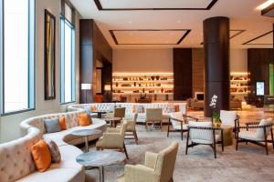 a lobby with couches and tables and chairs at The Westin Milwaukee in Milwaukee