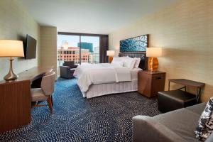 a hotel room with a bed and a desk and a couch at The Westin Milwaukee in Milwaukee +49 photos