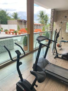 a fitness room with two exercise bikes on a balcony at Pousada Tropical Paulo Afonso in Paulo Afonso