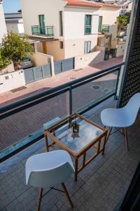 a table and two chairs on a balcony at Villas Horizonte Capazi in Porto Santo