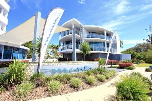 a building with a surfboard in front of it at Manta Bargara in Bargara