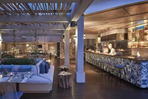 a restaurant with a blue couch and a bar at Yogyakarta Marriott Hotel in Yogyakarta