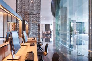 an office with two computer monitors on a desk at Yogyakarta Marriott Hotel in Yogyakarta