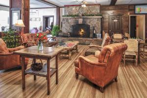 a living room filled with furniture and a fireplace at The Historic Crag's Lodge in Estes Park