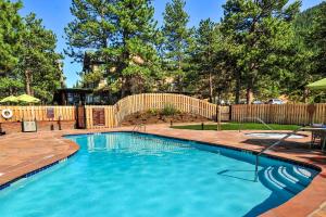 a swimming pool in a yard with a wooden fence at The Historic Crag's Lodge in Estes Park