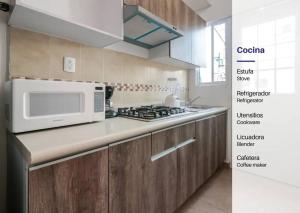 a kitchen with a microwave and a counter top at Maktub Casa AcaCancún in Barra Vieja