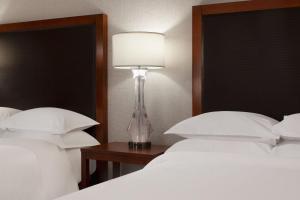 a lamp sitting on a table next to two beds at Sheraton Anchorage Hotel in Anchorage