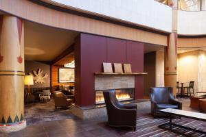 a lobby of a hotel with a fireplace at Sheraton Anchorage Hotel in Anchorage