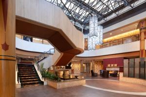 a lobby with a spiral staircase in a building at Sheraton Anchorage Hotel in Anchorage