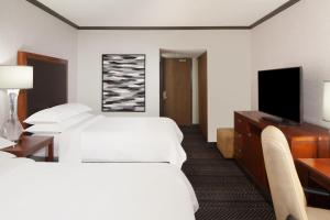 a hotel room with two beds and a flat screen tv at Sheraton Anchorage Hotel in Anchorage