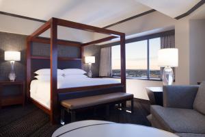 a hotel room with a bed and a chair at Sheraton Anchorage Hotel in Anchorage