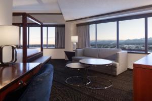 a hotel room with a couch and a table at Sheraton Anchorage Hotel in Anchorage