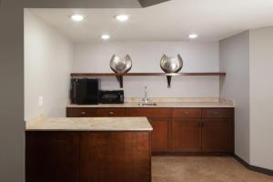 a kitchen with a sink and a microwave at Sheraton Anchorage Hotel in Anchorage