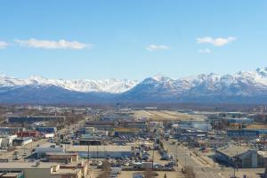 an aerial view of a city with snow covered mountains at Sheraton Anchorage Hotel in Anchorage