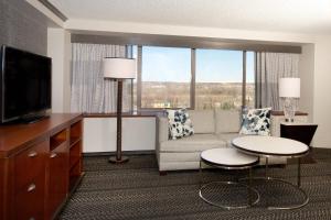 a living room with a couch and a tv at Sheraton Anchorage Hotel in Anchorage