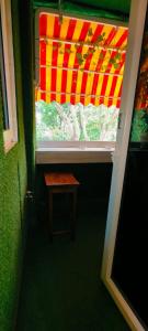 a window with a wooden stool in front of it at Vinanda Home Stay in New Delhi