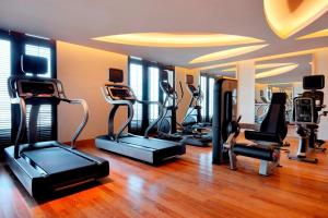 a gym with several treadmills and elliptical machines at Marriott Executive Apartments Al Jaddaf, Dubai in Dubai