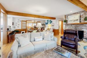 a living room with a white couch and a fireplace at The Pond of West Tisbury in West Tisbury