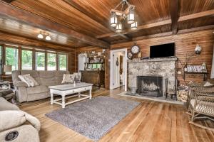 a living room with a couch and a fireplace at Lakeside Cottage on Katherine in Hazelhurst