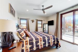 a bedroom with a bed and a desk and a window at Grand Central in Grand Lake