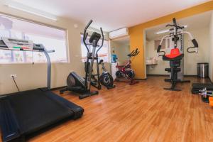 a gym with treadmills and exercise bikes in a room at El Camino Hotel & Suites in Heroica Caborca