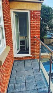 a door to a brick building with a window at The Chic Nexus Apartment 2023 New-Build in Oxford