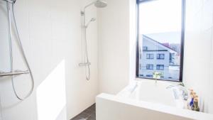 a white bathroom with a shower and a sink at hirafu188 in Kutchan +60 photos