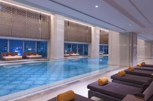 a swimming pool in a hotel with a view of the city at Sheraton Grand Wuhan Hankou Hotel - Let's take a look at the moment of Wuhan in Wuhan