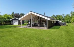 a house with a large yard with green grass at Gorgeous Home In Hals With Sauna in Hals