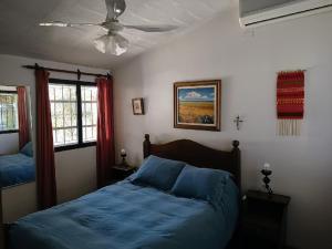 a bedroom with two beds and a ceiling fan at Complejo Los Aromos, San Juan, AR in San Juan