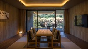 a dining room with a wooden table and chairs at KINUGAWA KEISUI in Nikko