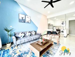 a living room with a couch and a table at SilverScape l A4011 l Luxury 3BR l Bathtub l 6-11 pax l Seaview l Infinity Pool l Jonker Street l City Centre by Jay Stay in Melaka