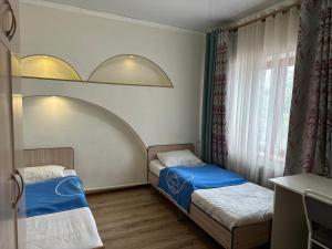 Postel nebo postele na pokoji v ubytování Tunduk Hostel