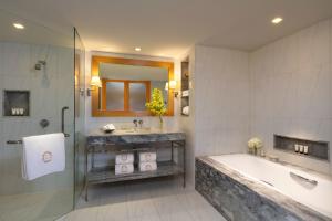 a bathroom with a tub and a sink and a shower at Tower Club at lebua in Bangkok