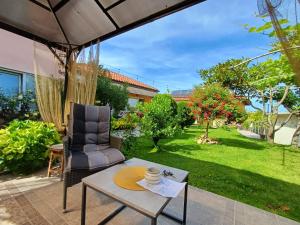 a patio with a table and a chair at Dom Zaharievi in Byala