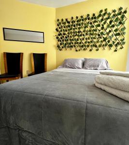 a bedroom with a large bed with two towels on it at VANILLA appartment in Ciudad Hidalgo