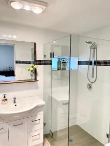 a bathroom with a shower and a sink at Private Bath Ensuite Room Eastwood/MQ Uni park in Sydney