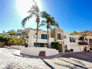 una casa grande con palmeras delante en Villa Cola de Ballena, Pedregal @ Cabo's Downtown en Cabo San Lucas
